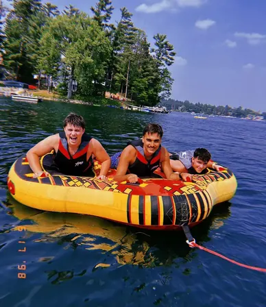 Tres counselors en un flotador en el lago